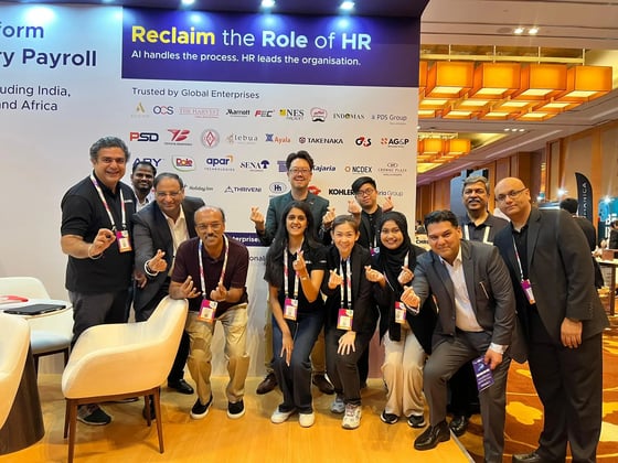 Large group of team members and attendees posing together at the HONO booth during the TechHR event.